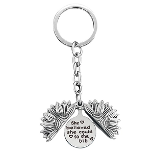 Detail of sunflower locket keychain with engraved inspirational quote and heart