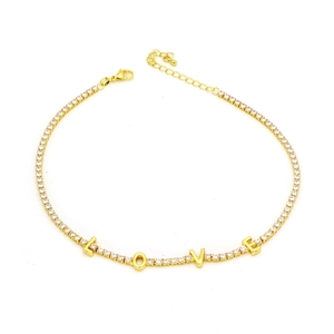 Gold tennis bracelet featuring crystal LOVE charms and adjustable lobster clasp
