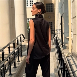 Elegant sleeveless high neck black satin top with button detail and asymmetric design