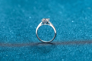 Macro shot of princess cut moissanite set in a polished S925 silver four-prong ring