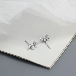 Macro detail of S925 silver earrings featuring cluster pearls and marquise cubic zirconia