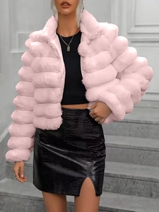 Detail of pink faux fur coat featuring layered horizontal stripes and fluffy texture