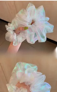 Close-up of oversized iridescent laser organza scrunchie with shimmering texture
