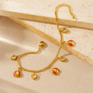 Golden stainless steel bracelet with red enamel ladybug and sparkling heart pendants