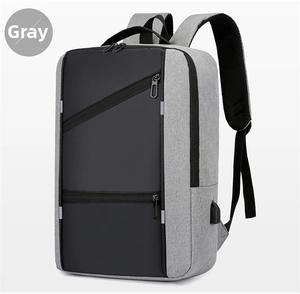 Detail of grey business laptop backpack featuring integrated USB charging port and zipper