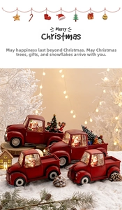 Close-up of vintage red Christmas truck ornaments with glowing water globes and festive scenes