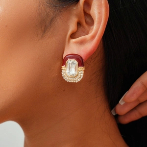 Detailed view of vintage earring with red enamel and large rectangular zircon stone