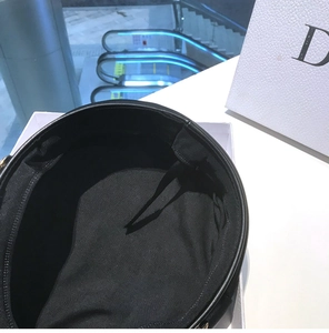 Close-up of black beret interior showing adjustable drawstring and lining texture