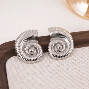 Polished silver geometric conch shell earrings displayed on a natural wooden tray