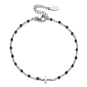 Macro detail of silver stainless steel cross bracelet with black beads and lobster clasp