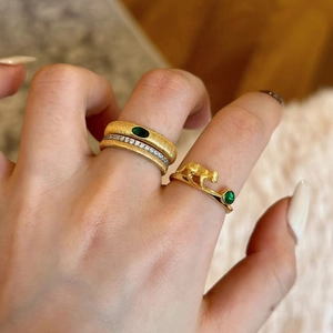 French vintage emerald rings with textured gold leopard and hammered band detail