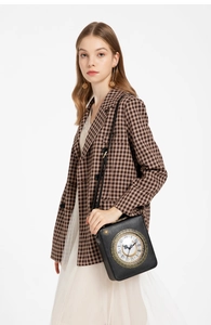 Elegant woman wearing retro clock-shaped crossbody bag over a brown checkered blazer