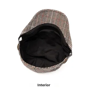 Detail view of the vintage plaid cap with black fabric lining and bronze metal buckle