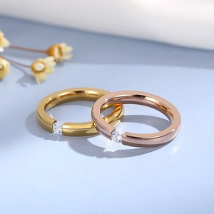 Polished gold and rose gold stainless steel rings featuring a delicate inset zircon stone
