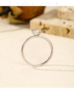 Close-up of geometric Moissanite ring in S925 sterling silver on a beige textured background