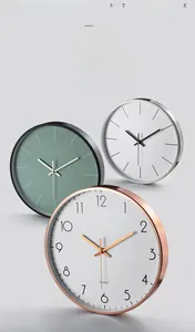 Detail of minimalist 12-inch metal wall clocks showing brushed aluminum frames and quartz dials