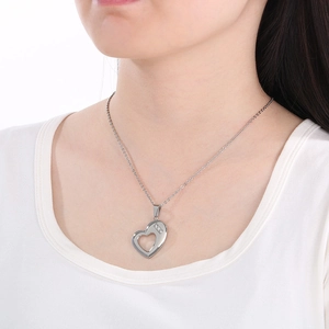 Close-up of hollow heart necklace with three small diamonds on a polished O-chain