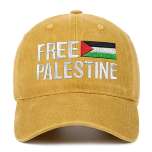 Detailed close-up of Free Palestine 3D embroidery on a yellow vintage cotton baseball cap