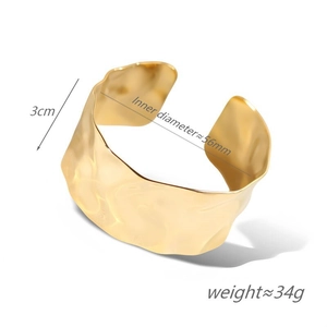 Detail view of gold wide irregular cuff bracelet with 3cm width and 56mm inner diameter