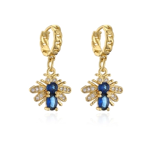 Detailed close-up of gold plated bee earrings with blue oval stones and clear zircon wings