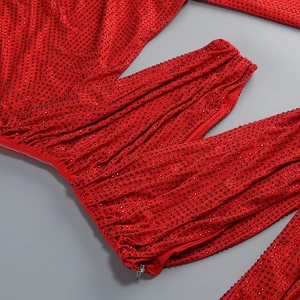 Detail of red rhinestone dress showing high-density gems and a hidden zipper closure