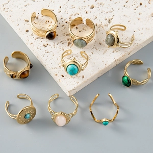 Detailed macro view of Bohemian style gold rings set with colorful turquoise and semi-precious stones