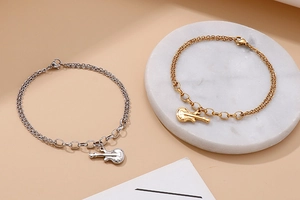 Detail view of gold and silver guitar pendant bracelets with double-layered chain link