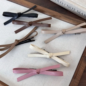 Set of five vintage leather bow hair clips in assorted coffee and neutral tones