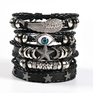 Detailed stack of multi-layer leather bracelets with feather wing and evil eye charms