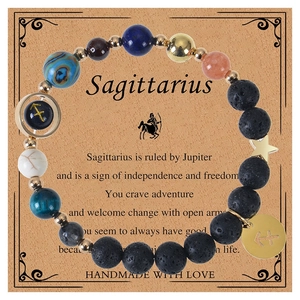 Detail of Sagittarius natural stone bead bracelet with zodiac charm on gift card