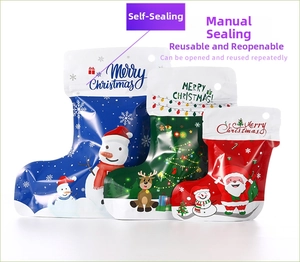 Three colorful Christmas stocking-shaped resealable bags with Santa and reindeer designs