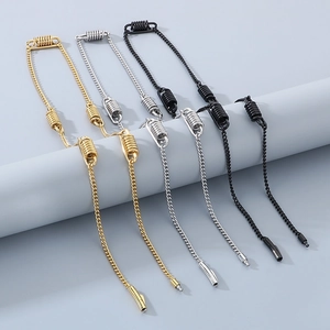 Detail of stainless steel spring necklaces in gold, silver and black finishes