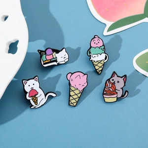 Detailed set of five cartoon cat and ice cream enamel pins on a blue background