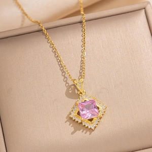 Luxurious gold necklace with a square pink zircon pendant in a beige jewelry box