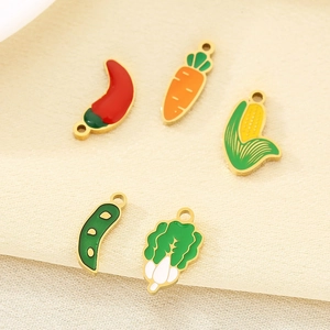 Detailed close-up of colorful vegetable charms in gold finish for DIY jewelry