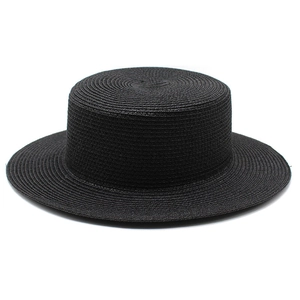 Close-up of black straw boater hat showing fine circular woven texture and flat top