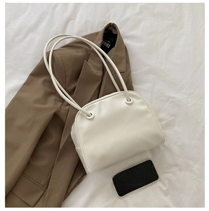 White minimalist underarm bag shown with a mobile phone for size scale comparison