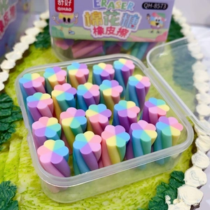 Close-up of flower-shaped colorful erasers in a clear plastic box on a green base