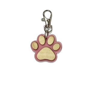 Detail view of pink acrylic paw print keychain with natural wood inlay and silver lobster clasp