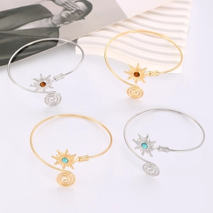 Detail of adjustable sun arm cuff with turquoise stone in gold and silver finishes