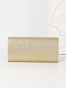 Detail showing gold glitter sequin texture on a rectangular evening clutch bag