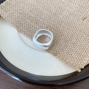 Minimalist 925 sterling silver square ring with matte finish on beige linen backdrop