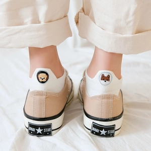 Beige canvas sneakers with animal embroidery ankle socks shown from a rear view