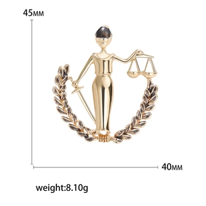 Golden Lady Justice Libra brooch with scales and sword, measuring 45mm by 40mm