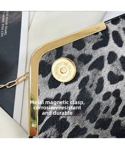 Detailed view of the gold magnetic closure and metal frame on the leopard print bag