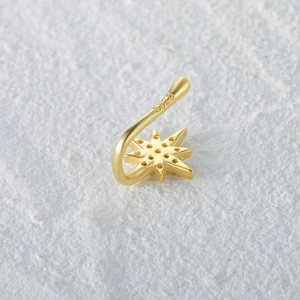 Macro shot of S925 sterling silver stamp on golden star-shaped nose cuff jewelry
