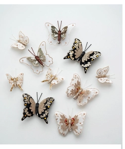 Detailed view of handmade Christmas butterfly ornaments with sequins and bead embroidery