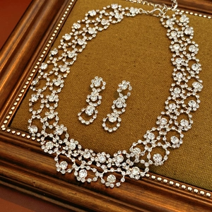 Detail of luxury rhinestone silver jewelry set with tassel necklace and earrings