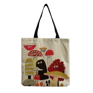 Detail of cute mushroom print on beige canvas tote bag with black durable handles