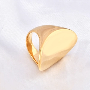 Detailed close-up of a 18k gold plated curved irregular ring on white silk fabric